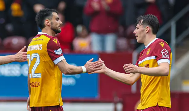 Motherwell's John Koutroumbis (L) celebrates scoring to make it 2-1