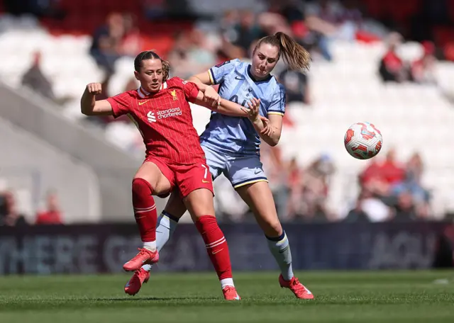 Cornelia Kapocs of Liverpool is challenged by Ella Morris of Tottenham Hotspur during the Barclays Women's Super League match between Liverpool FC and Tottenham Hotspur FC at the Totally Wicked Stadium on April 27, 2025 in Liverpool, England.