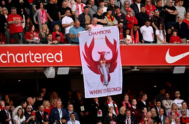 Fans of Liverpool display a banner