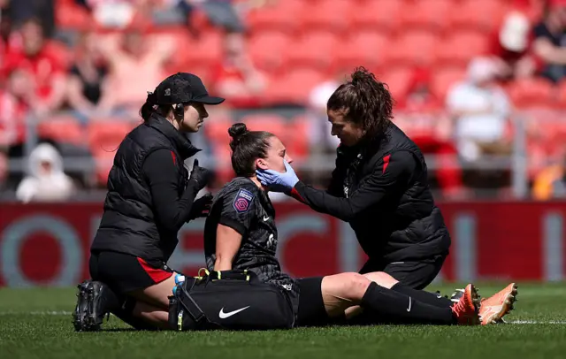 Rachael Laws of Liverpool receives medical treatment for a head injury after collision during the Barclays Women's Super League match between Liverpool FC and Tottenham Hotspur FC at the Totally Wicked Stadium on April 27, 2025 in Liverpool, England.