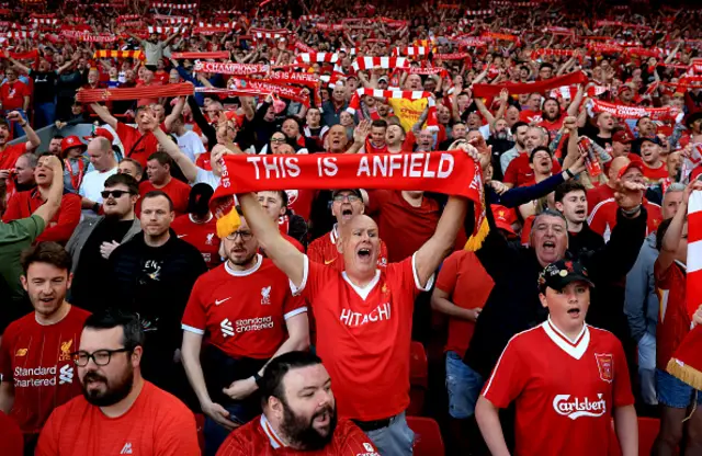 Fans of Liverpool hold up scarfs