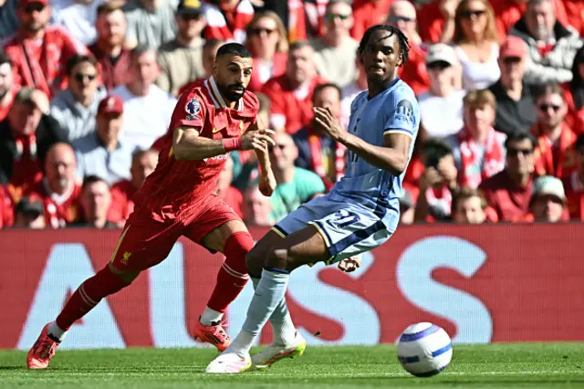 Mohamed Salah (L) vies with Tottenham Hotspur's French striker Mathys Tel