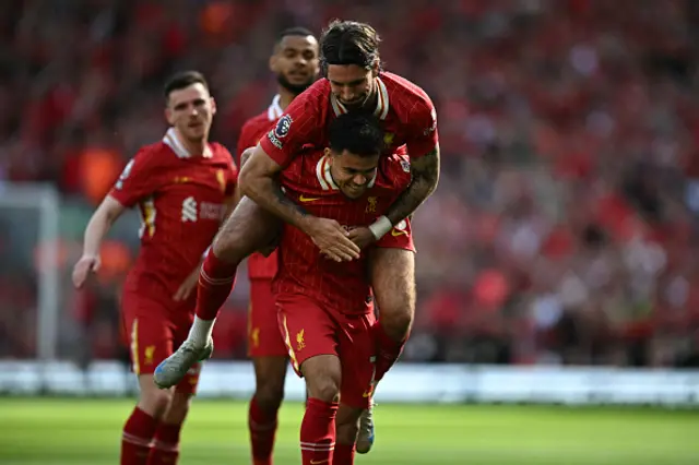 Dominik Szoboszlai leaps onto the back of Liverpool's Colombian midfielder Luis Diaz