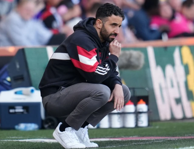 Manchester United manager Ruben Amorim looks on