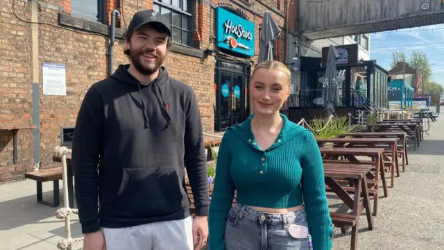 Liverpool fans Lewis (L) and Abigail (R) pose
