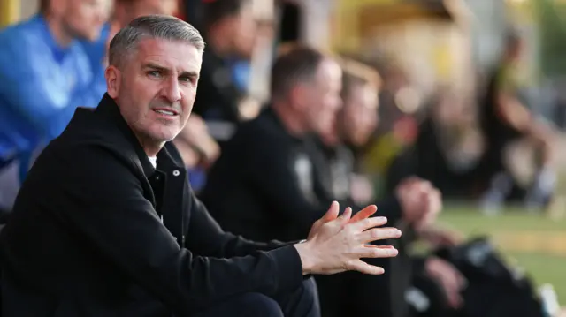 Wigan manager Ryan Lowe in the dugout at Burton