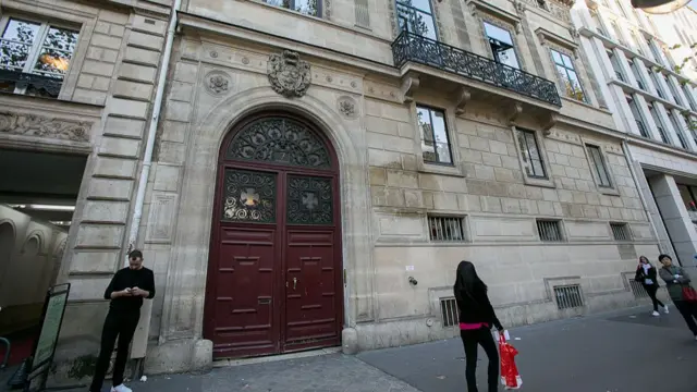 A large red door on a Parisian street
