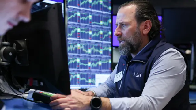 A man looking anguished in front of stock