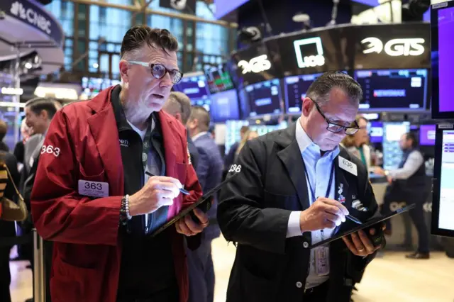 Traders at the New York Stock Exchange a short time ago
