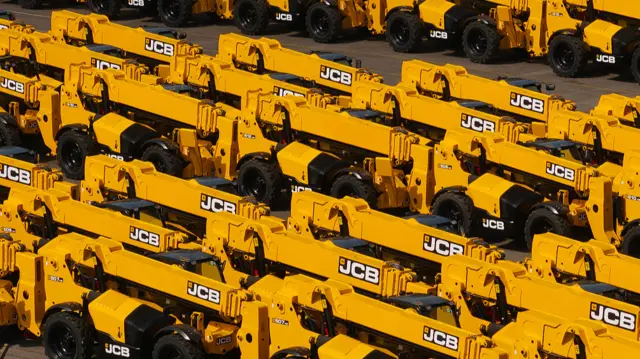 Yellow JCB construction trucks.
