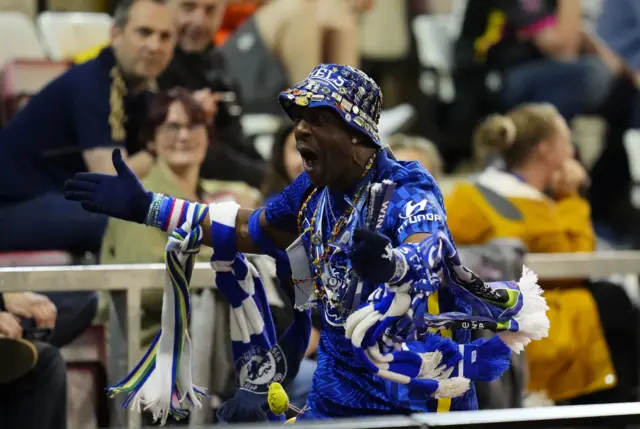 Chelsea fan known as Basil runs around celebrating in head to toe merchandise