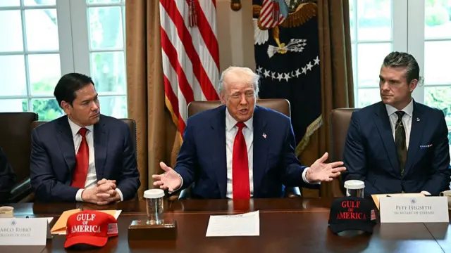 Donald Trump sitting next to Marco Rubio and Pete Hegseth