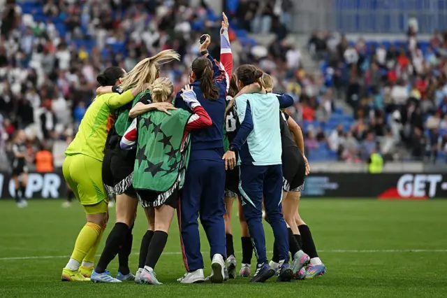Arsenal players celebrate at full time in Lyon