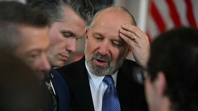 US Commerce Secretary Howard Lutnick speaks with Defense Secretary Pete Hegseth
