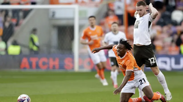 Marc Leonard of Birmingham City fouls Niall Ennis of Blackpool