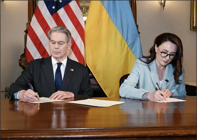 US Treasury Secretary Scott Bessent, and Ukrainian First Deputy Prime Minister Yulia Svyrydenko signing the deal.