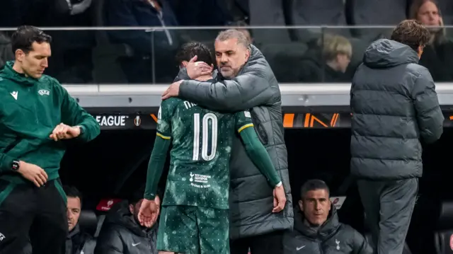 Tottenham Hotspur head coach Ange Postecoglou comforts James Maddison of Tottenham Hotspur during the UEFA Europa League 2024/25 Quarter Final Second Leg match between Eintracht Frankfurt and Tottenham Hotspur at Deutsche Bank Park on April 17, 2025