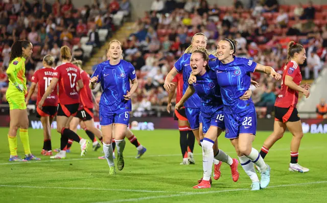 : Lucy Bronze of Chelsea celebrates scoring her team's first goal with team mate Wieke Kaptein of Chelsea during the Barclays Women's Super League match between Manchester United FC and Chelsea FC at Leigh Sports Village on April 30, 2025 in Leigh, England.
