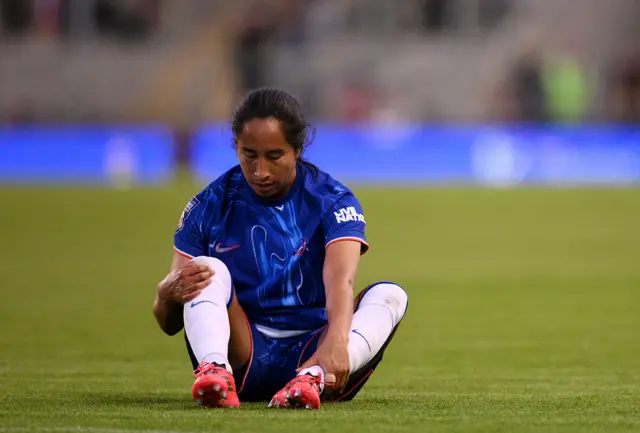 Ramirez sits on the floor holding her leg
