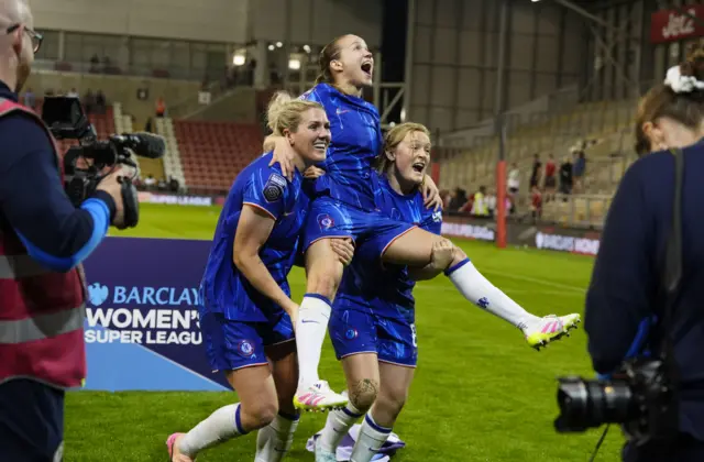 Chelsea's Millie Bright (left), Guro Reiten (centre) and Erin Cuthbert (right) celebrate winning the league after the Barclays Women's Super League match at Leigh Sports Village, Manchester