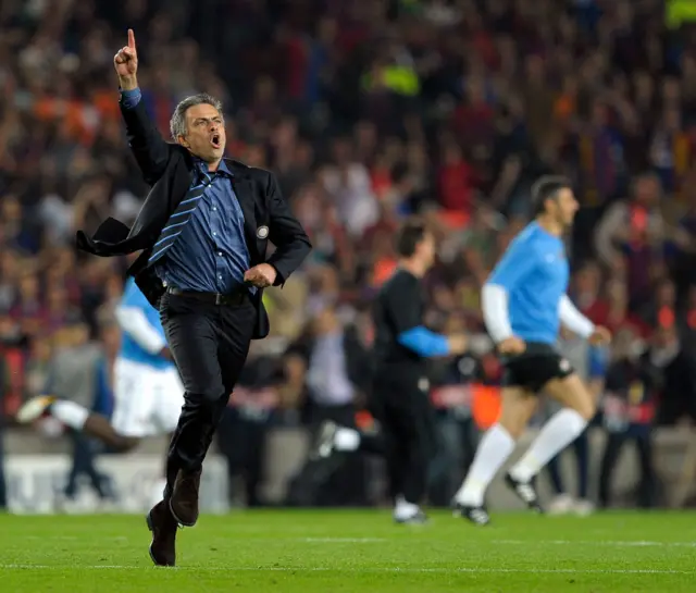 Jose Mourinho running with his finger in the air on the Nou Camp pitch
