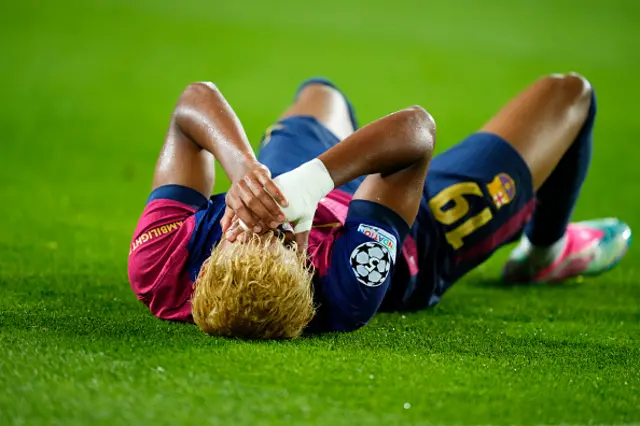 Lamine Yamal right winger of Barcelona and Spain lies injured on the pitch