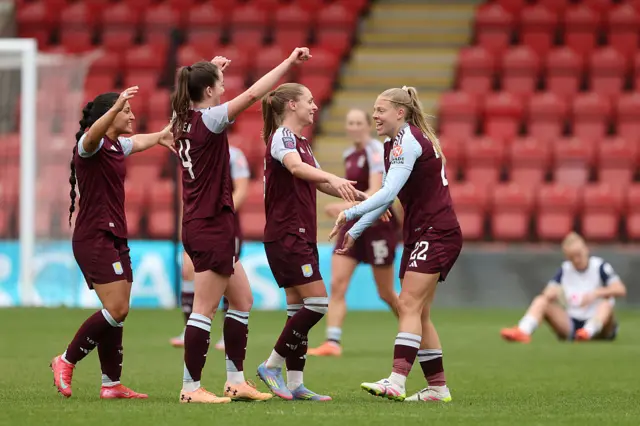 Aston Villa players celebrate at full time after beating Tottenham
