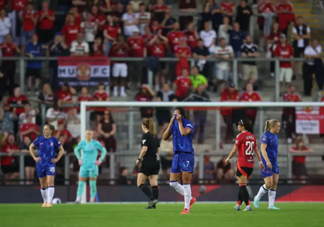 Ramirez covers her face as she walks off the pitch