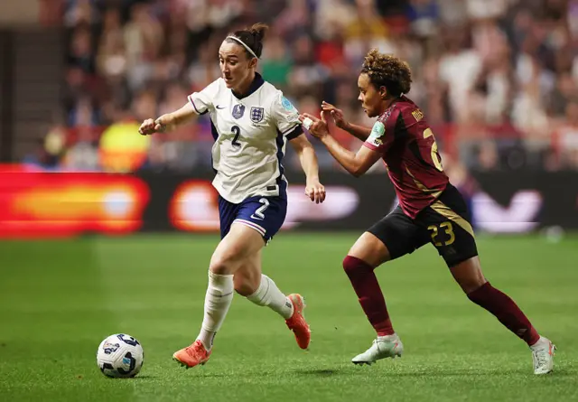 Lucy Bronze of England runs for the ball under pressure by Kassandra Missipo of Belgium