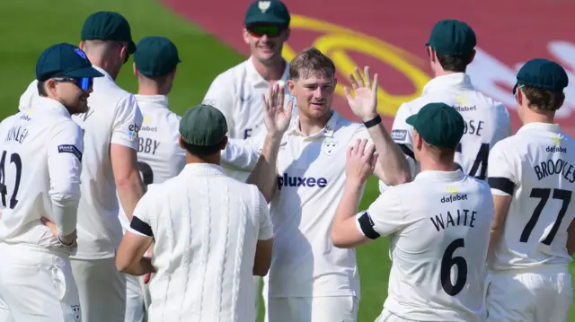 Tom Taylor celebrates the wicket of Archie Vaughan