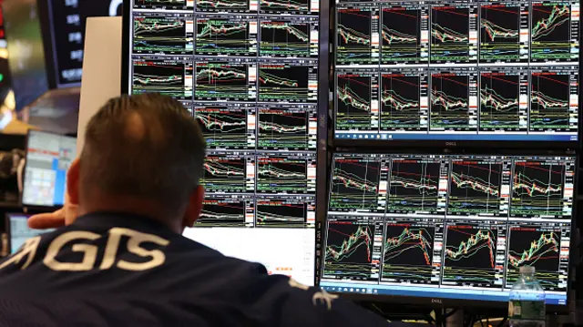 A trader works on the floor of the New York Stock Exchange April 4, 2025, in New York