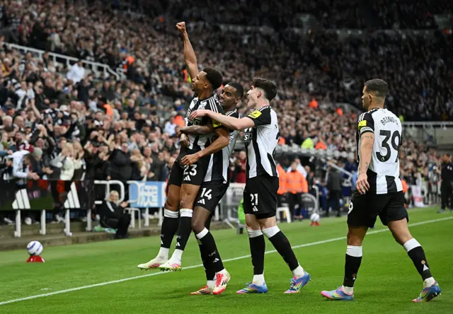 Alexander Isak of Newcastle United lifts up teammate Jacob Murphy who assisted him in scoring