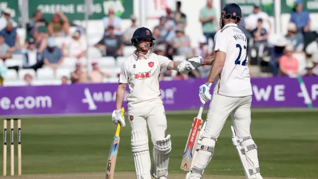 Jordan Cox and Paul Walter punch gloves after sharing a century stand