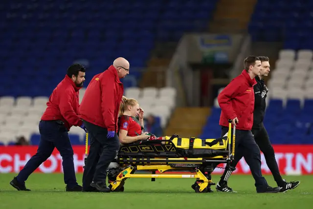 Ceri Holland is helped off