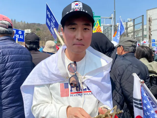 Edward Cho looking angry and red-faced