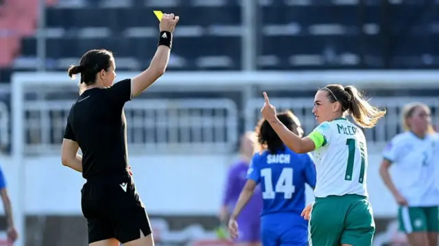 Republic of Ireland captain Katie McCabe is shown a yellow card