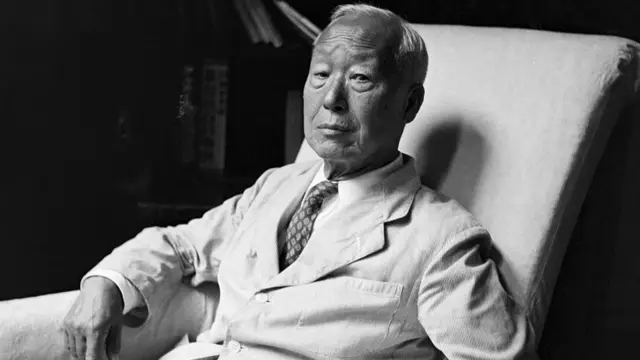 Black-and-white photo of Syngman Rhee sitting on an armchair and looking at the camera