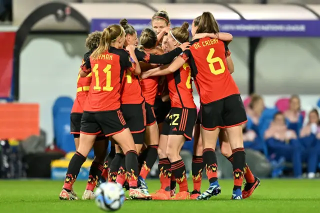 Belgium's Laura De Neve celebrates with her teammates after scoring