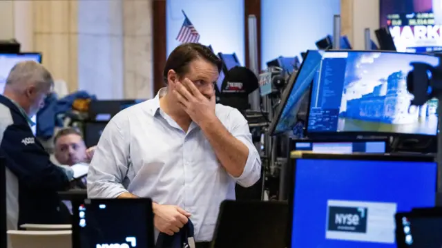 A trader at the end of the trading day on the floor of the New York Stock Exchange in New York, New York, USA, on 04 April 2025