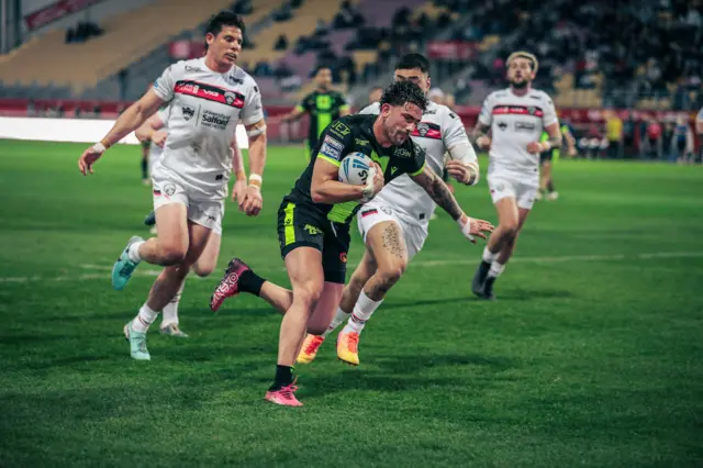 Catalans' Arthur Romano scores a try against Salford