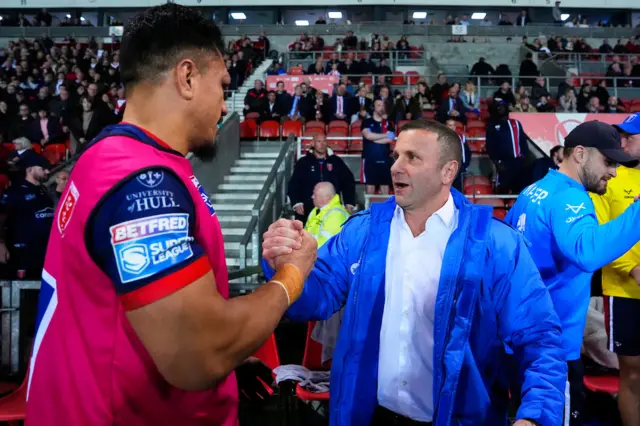 Hull KR head coach Willie Peters clasps hands with one of his players