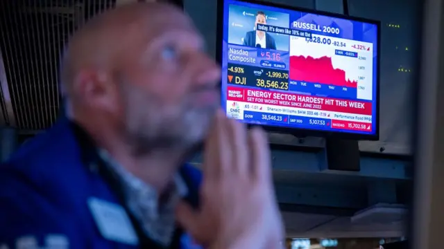 A television broadcasts market news on the floor of the New York Stock Exchange (NYSE) in New York