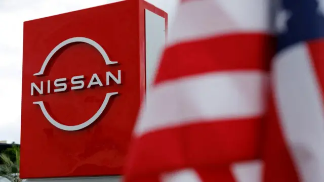 The American flag flutters at a Nissan automobile dealership in Irvine, California