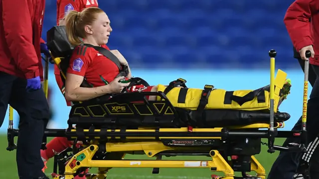 Ceri Holland leaves the field on a stretcher