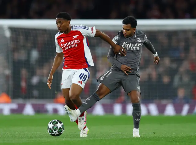 Arsenal's Myles Lewis-Skelly in action with Real Madrid's Rodrygo