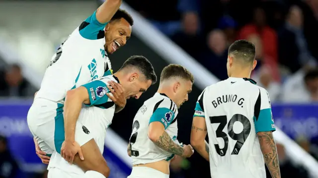 Newcastle players celebrate after scoring against Leicester