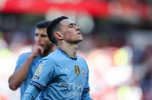 Phil Foden looks on