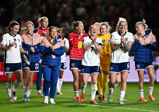Beth Mead, Millie Bright and Keira Walsh of England celebrate victory with team mates