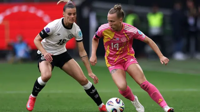 Rachel McLauchlan of Scotland is challenged by Selina Cerci of Germany