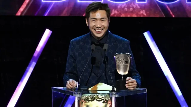 Jaeho Hwang standing at the podium, a grin on his face